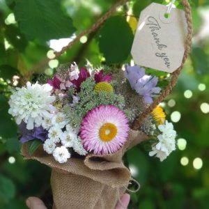 Posie of summer flowers in a hessain covered jar